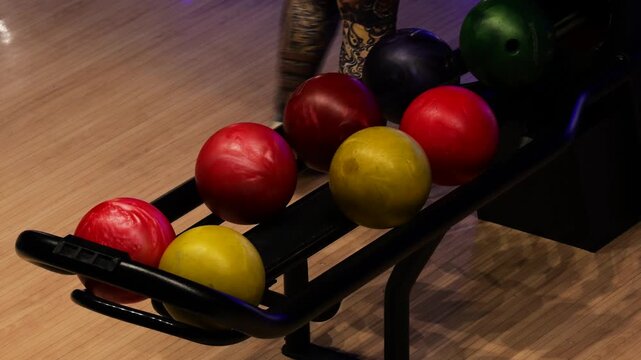 Colorful Bowling Balls in a Storage Rack at a Bowling Alley