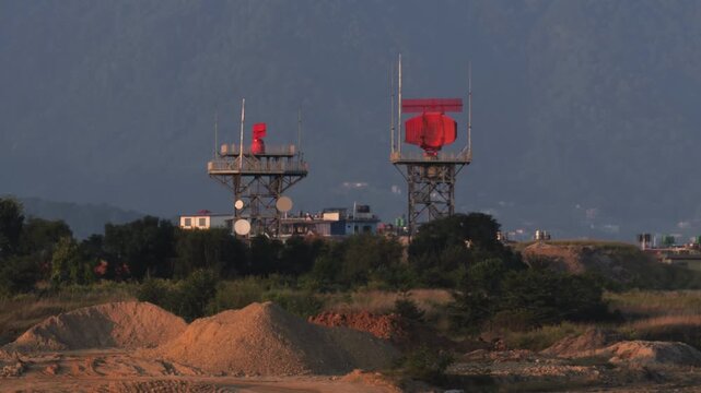 Aviation Radar Towers with Rotating Dishes Near Airport