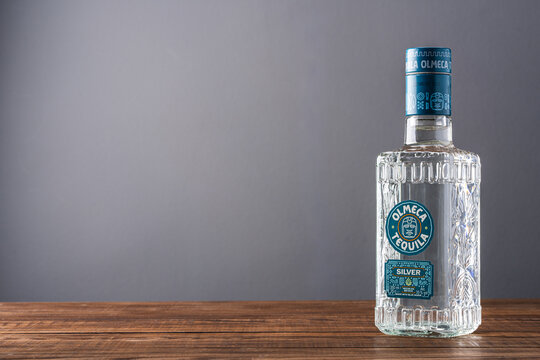 Bottle of silver  tequila on wooden table