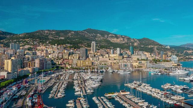 Timelapse of Monaco skyline and Port Hercule with dynamic city motion, shifting light, and yacht harbor activity, showcasing luxury lifestyle, urban energy, and Mediterranean coastal atmosphere.