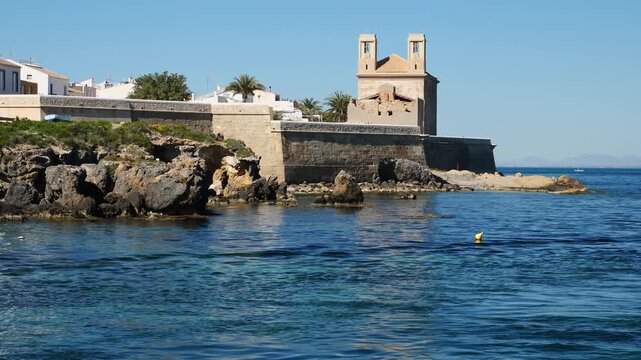 Church of Saint Peter and Saint Paul, and walls seen from the port. Tabarca island. Spain. Slow motion x0,5