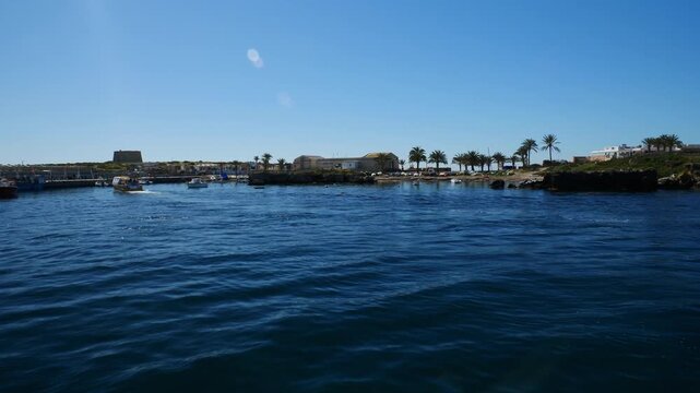 Arriving by boat at the small port on the island of Tabarca, Spain. Slow motion x0,5.