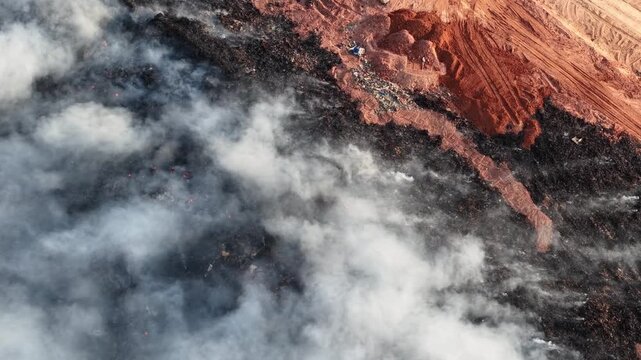 Aerial drone footage of fire burning at landfill site