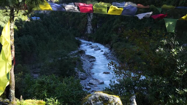 Buddhist Prayer Flags Hanging Above a River in the Himalayas, Nepal