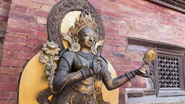 Bronze Deity Statue on a Brick Wall in Patan Durbar Square, Lalitpur, Nepal