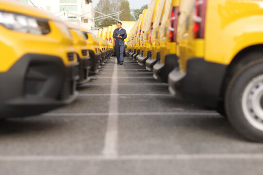 Mechanic walking through a fleet of yellow vans