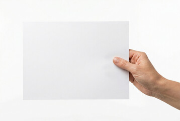 Obraz premium Female hand holding a large blank white sheet of A4 paper on an isolated white background