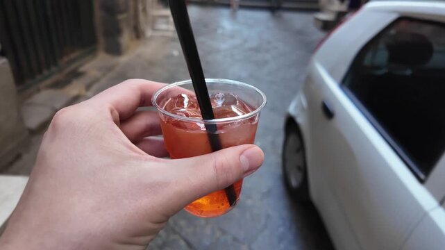 POV of Person Walking with a Refreshing Spritz Drink on the Street