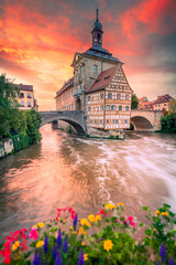 Fototapeta premium Bamberg, Bayern - Germany. Warm colors sunset over medieval downtown, vibrant sky and peaceful Regnitz river reflection