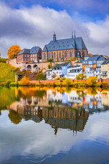 Fototapeta premium Saarburg, Germany. Water reflection landscape with charming old town on Saar River.