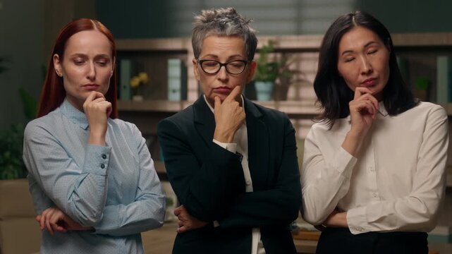 Three pensive multiracial business women different ages thinking thoughtful think in office diversity businesswomen hesitate pondering work ideas solutions multiethnic females create working plan