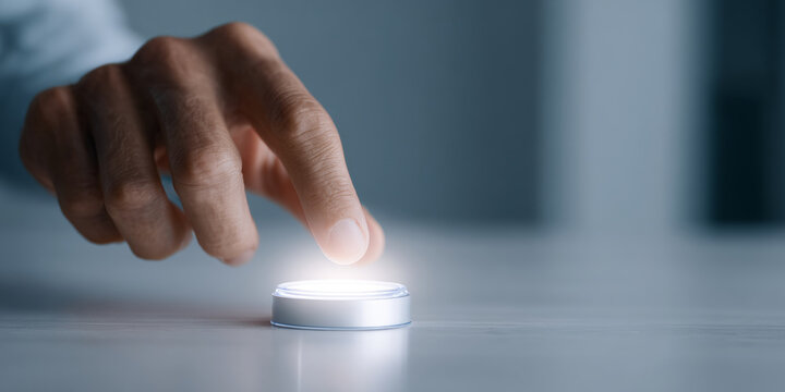 Hand pressing illuminated futuristic button
