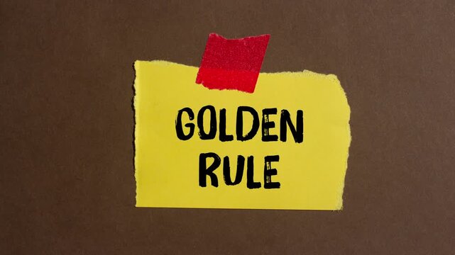 Golden rule message writing on ripped torn paper background