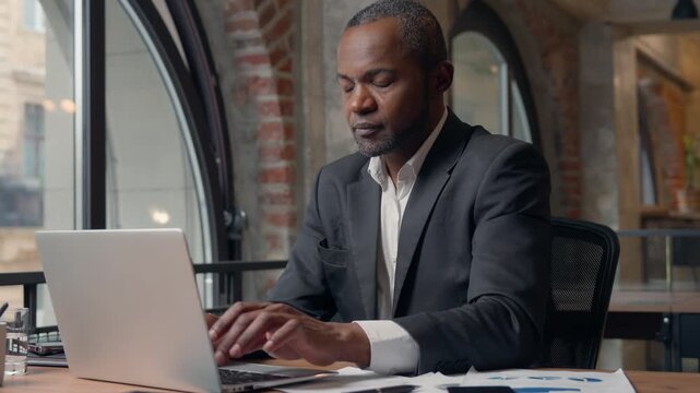 African American man businessman come up with business idea typing laptop middle-aged worker male ethnic manager thinking create planning work decision using computer pc internet cyberspace working