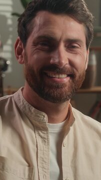 Smiling Caucasian buyer client adult man holding bunch of keys in living room in luxury new home male smile with key buying property moving day relocation house bank invest mortgage achive ownership