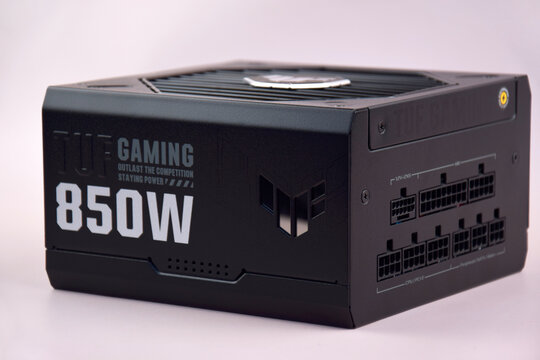 Computer AC power supply Asus Tuf 850w on a light background.