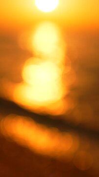 Sunset ocean bokeh blurred golden sun setting over the tranquil sea creating a warm and peaceful atmospheric background for vacation and nature concepts