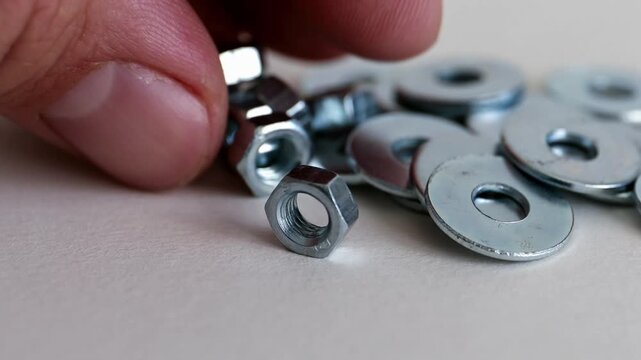 Hex Nuts and Flat Washers on White Background Close Up Hardware Set