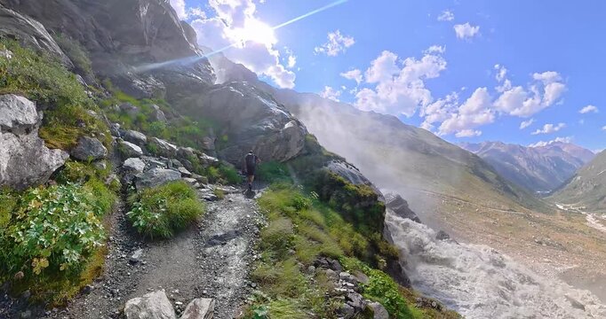 Hiking group ascending beside Pitztal waterfall in Alps Austria