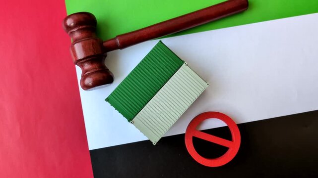 The cargo container ban on the UAE flag as a conceptual backdrop for the export and logistics of goods. The cargo container embargo on the UAE flag as a backdrop for your design