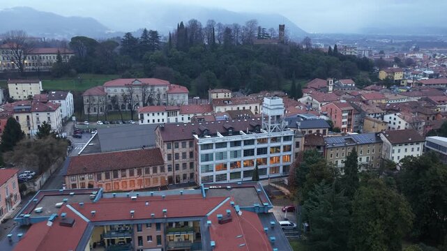 Aerial drone footage featuring a smooth pullback combined with rotation from Lanificio Conte, a historic industrial complex in Schio, Italy.