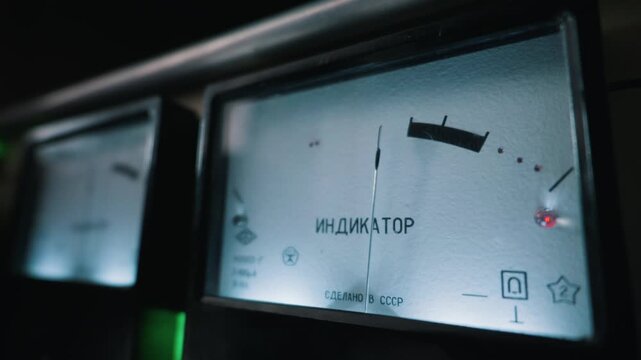 A vintage analog audio level meter glows softly while showing signal strength. The Cyrillic text translates to indicator in English. This represents a classic concept of retro sound engineering.