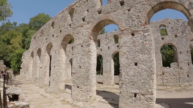 Ancient Byzantine stone ruins, walls and brick arches at historic archaeological site of Butrint National Park in Albania.