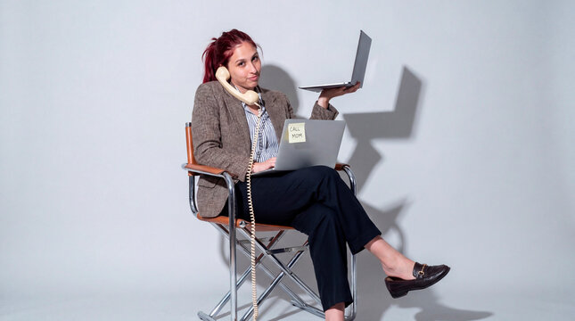 Resourceful professional handling simultaneous calls and digital devices in office setting