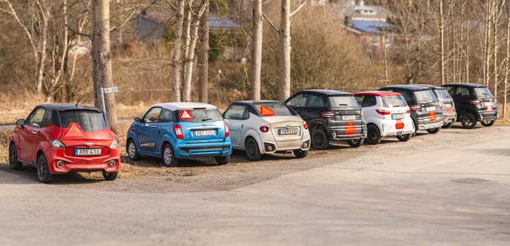 Kungsbacka, Sweden - March 20 2026: Swedish microcars parked with warning triangles along quiet roadside.