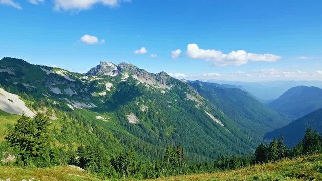 A high-definition footage capturing the panoramic views along the steep and rocky Pinnacle Peak Trail in the Tatoosh Range, Mount Rainier National Park, Washington. This popular hiking trail offers ex