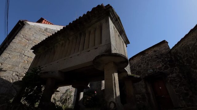 Approaching a Traditional Galician Horreo on a Steep Village Street