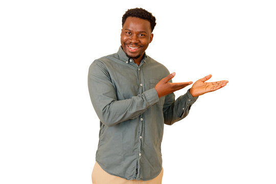 Young black man smiling, presenting and displaying with open hands, offering or recommending products, services, or information on transparent background