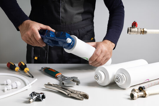  Home water filtration system. Technician installing or repairing system of water filtration.