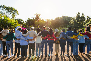 Group of multigenerational people hugging each others - Support, multiracial and diversity concept - Main focus on senior man with white hairs © DisobeyArt
