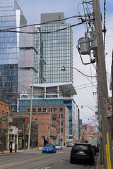 Naklejka premium looking east on King St E to historic brick buildings contrast with modern office building at 280 King St E, Toronto