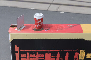 Obraz premium discarded Tim Hortons beverage cup on a concrete divider in Toronto