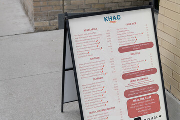 Obraz premium sidewalk A-frame with menu for Khao Hakka, restaurant, located at 37 Sherbourne St inside The East Lofts Condos, Toronto