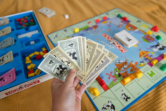 Hand holding Monopoly money during gameplay