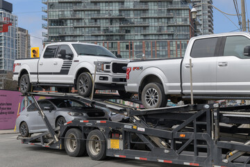 Fototapeta premium multi-level auto transporter turning on Front St E at intersection of Parliament St, Toronto