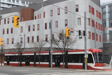 Fototapeta premium streetcar and exterior of Anishnawbe Health, a medical clinic, located at 425 Cherry St, Toronto