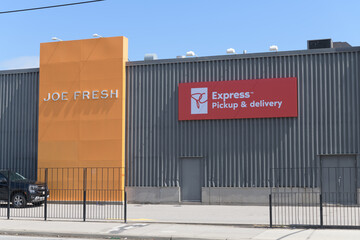 Fototapeta premium exterior building and signs of Joe Fresh and PC Express Pickup & delivery at 17 Leslie St, Toronto