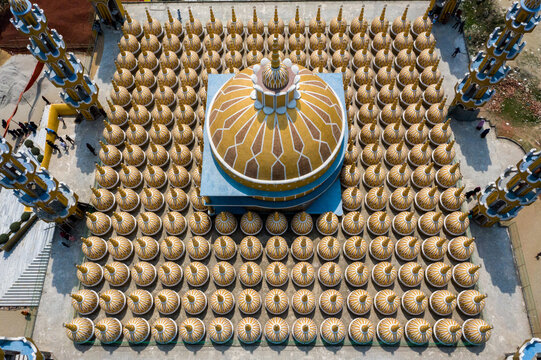 Aerial view of the vibrant, golden dome of the 201 Dome Mosque rises majestically above the surrounding structures, Tangail, Bangladesh.