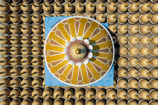 Aerial view of a resplendent central dome in gold and white, starkly contrasting with numerous smaller, shimmering golden domes, Tangail, Dhaka Division, Bangladesh.