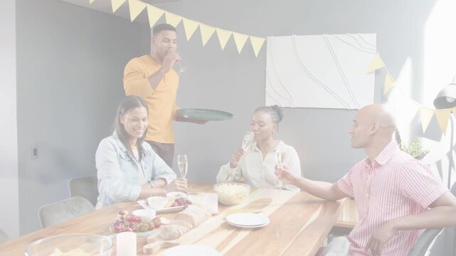 Host serving flutes, friends clinking glasses and conversing during hospitality toast with bubbles
