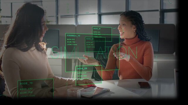 Two coworkers meeting, left using red mouse activating green HUD, right rotating sample for design