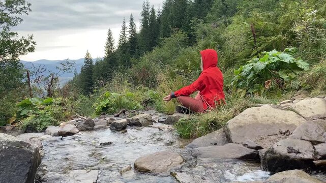 woman meditate near Tranquil Mountain river and beautiful mountain Environment