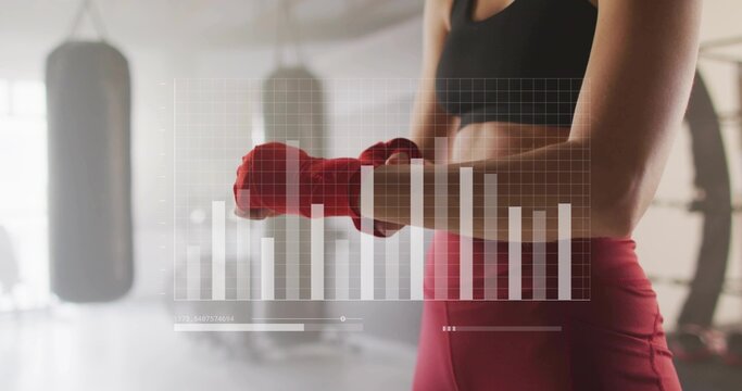 Female athlete securing red hand wraps in studio with HUD overlay, black sports bra, copy space