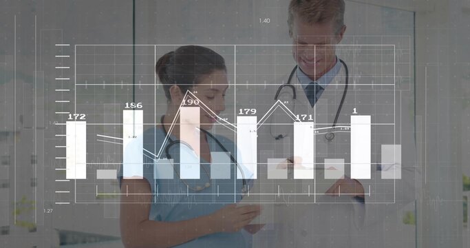 Reviewing nurse in scrubs and doctor in coat in clinic, leaning over tablet showing chart overlay