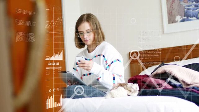 Woman tapping phone on bed and using tablet, monitoring data, tech charts expanding across bed