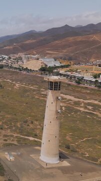 Aerial view of the beach and the lighthouse Faro de Morro Jable, Fuerteventura, Canary Islands, Spain.